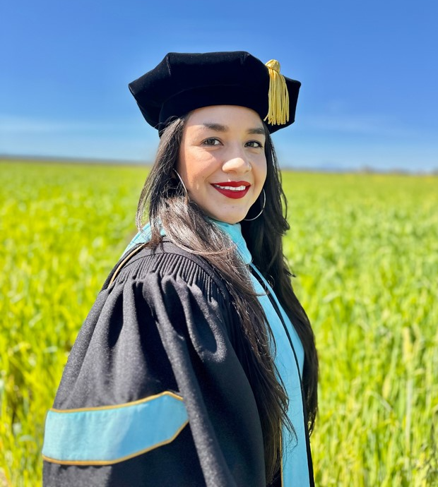 woman in graduation clothing smiling